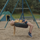 A young girl on a tire swing